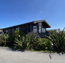 A house surrounded by plants and a pathway at Lamorna, Sennen