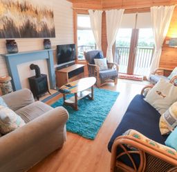 A living room with sofas and a television at Lamorna in Sennen