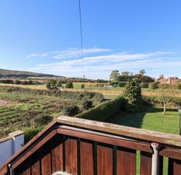 A view of fields and trees from a balcony at East Cottage East Knapton near Rillington
