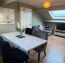 A dining room with a table and chairs at West Cottage in East Knapton near Rillington