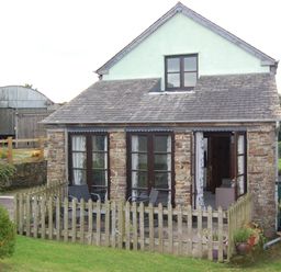 A house with a porch and garden at The Milking Shippon at Thorne Langtree near Great Torrington
