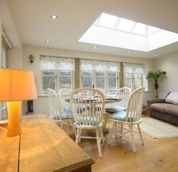 A dining room with a table and chairs at The Coach House in Burford