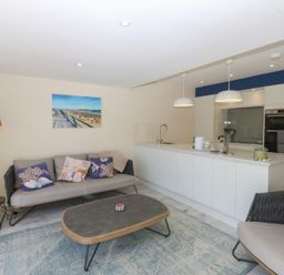 A living room with a sofa and coffee table at 2 Lon Y Dryw in Trearddur Bay
