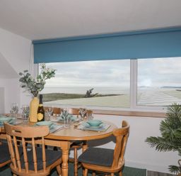 A dining room with a table set for meals at Ysgo - 6 Ty'n Don Abersoch