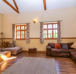 A living room with sofas and a coffee table at Millbarn in Crowcombe