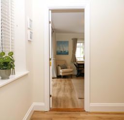 A hallway with a plant and a view of a living room at 2 Sheplegh Court Blackawton near Dartmouth