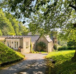 A house with a driveway and trees at 2 Sheplegh Court Blackawton near Dartmouth