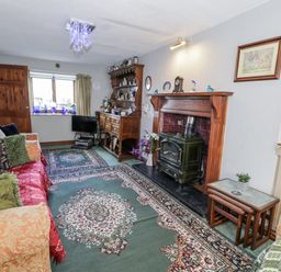 A living room with a fireplace and sofa at The Old Post Office in null