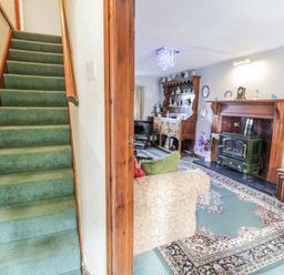 A living room with a sofa and fireplace at The Old Post Office in null