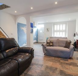 A living room with sofas and a staircase at Lenny's Place in Watchet