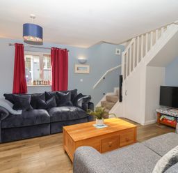 A living room with a sofa and coffee table at Mayfly Lodge in St Tudy