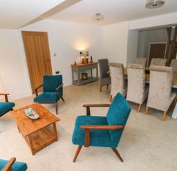 A dining room with a table and chairs at Hawthorns