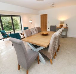 A dining room with a table and chairs at Hawthorns 