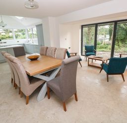 A dining room with a table and chairs at Hawthorns