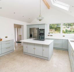A kitchen with an island and appliances at Hawthorns in 