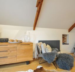 A living room with a television, speaker and wooden dresser at The Dairy in 