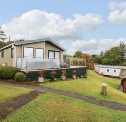 A house with a deck and plants outside at The Hideaway in Pwllheli