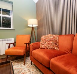 A living room with a sofa and armchair at The Studio in Windermere
