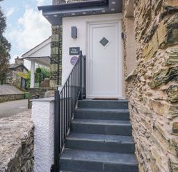 An entrance staircase with a door at The Studio in Bowness-On-Windermere
