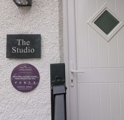 An entrance with a door and a name plaque at The Studio in Bowness-On-Windermere