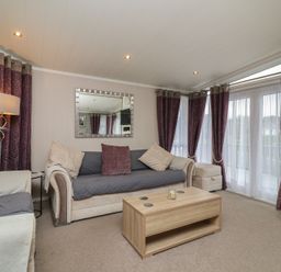 A living room with a sofa and coffee table at Whistler in Wimborne