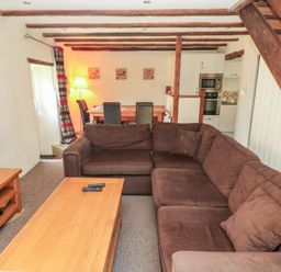 A living room with a sofa and coffee table at Carthouse Cottage in Clarbeston Road