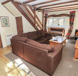 A living room with a sofa and coffee table at Carthouse Cottage in Clarbeston Road