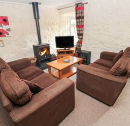 A living room with sofas and a coffee table at Stable Cottage in Clarbeston Road
