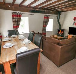 A dining room with a table set for dinner at Shippen Cottage Clarbeston Road