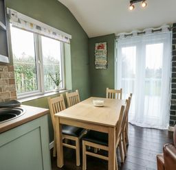 A dining room with a table and chairs at Harbour Lights in Holyhead