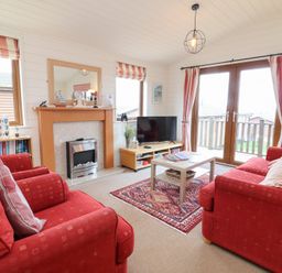 A living room with a television and sofa at Ocean Terrace 28 Ilfracombe