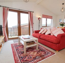 A living room with a sofa and coffee table at Ocean Terrace 28 Ilfracombe