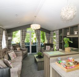 A living room with sofas and a coffee table at Feather Hill Lodge White Cross Bay near Troutbeck Bridge