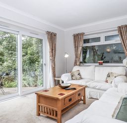 A living room with a sofa and coffee table at Mayflower View in Dawlish