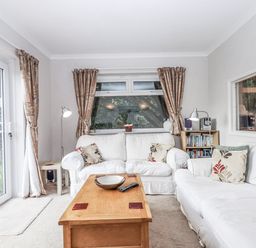 A living room with a sofa and coffee table at Mayflower View Dawlish