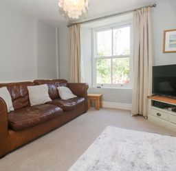 A living room with a sofa and television at Pedn Brose Near Mousehole