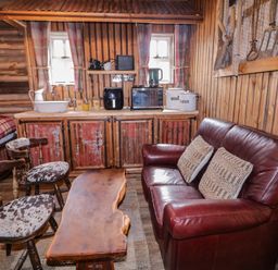 A living room with a sofa and coffee table at Rusty Barn in Limavady