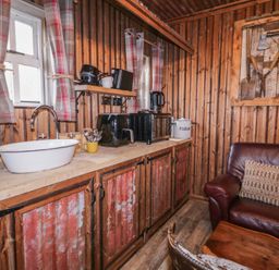 A kitchen with a sink and cabinets at Rusty Barn in Limavady