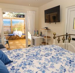 A bedroom with a bed and a television at Sea Folly