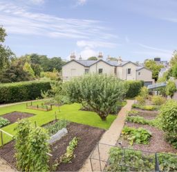 A garden with vegetable beds and a pathway at St Anne's Manor in Torquay