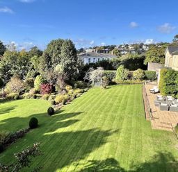 A garden with a lawn and seating area at St Anne's Manor in Torquay