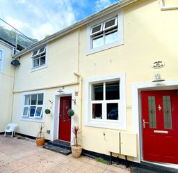 An outdoor entrance with red doors and windows at Upper Stable - The Stables Apartments at Meadfoot Bay, Torquay