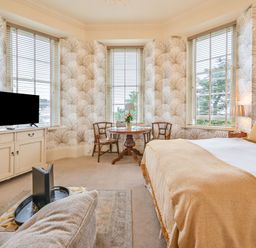 A bedroom with a bed and a table at Muntham - Studio Apartment 7 Torquay