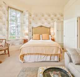 A bedroom with a bed and table at Muntham - Studio Apartment 7 in Torquay