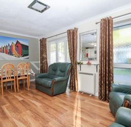A living room with a dining area and seating at Willow Lodge Rosecraddoc Lodge near Liskeard
