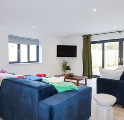 A living room with a sofa and coffee table at Barn 5