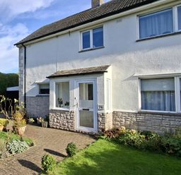 A house with a front porch and garden at Apple Byrd in Kendal