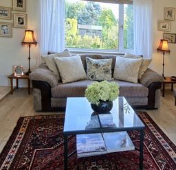 A living room with a sofa and table at Apple Byrd in Kendal