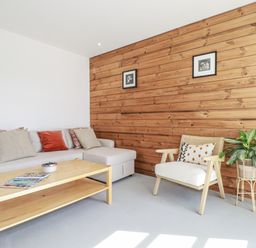 A living room with a sofa and coffee table at Teach Tra East, Perranporth