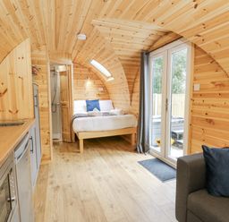 A studio with wooden walls and a bed at Oak View in Rhayader